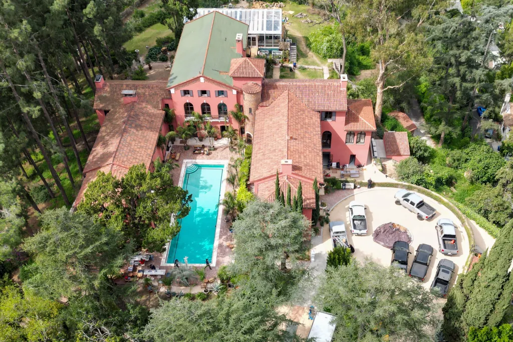 Aerial view of Paramour Estate with a pool and parked cars.