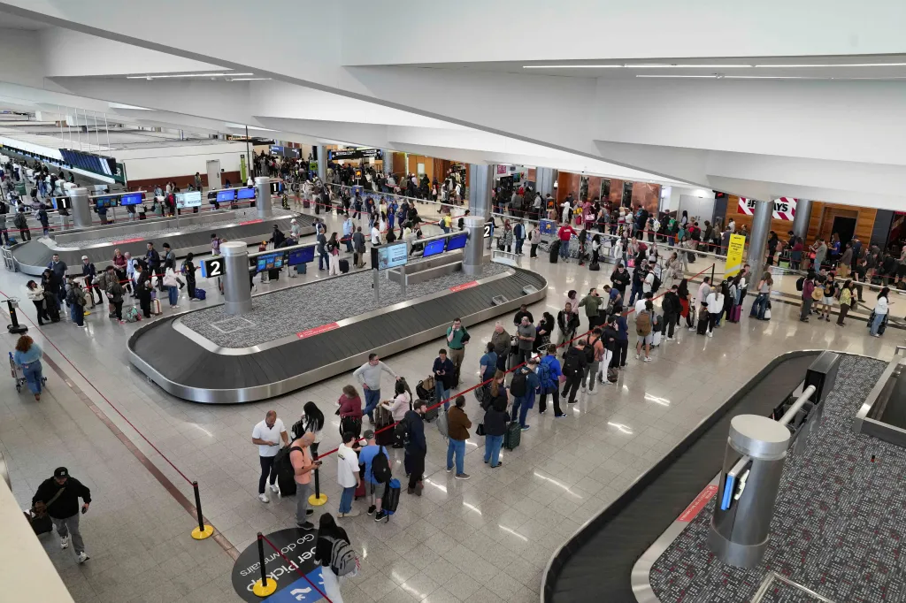 TSA lines at Atlanta's Hartsfield-Jackson International Airport snake past baggage claim areas.