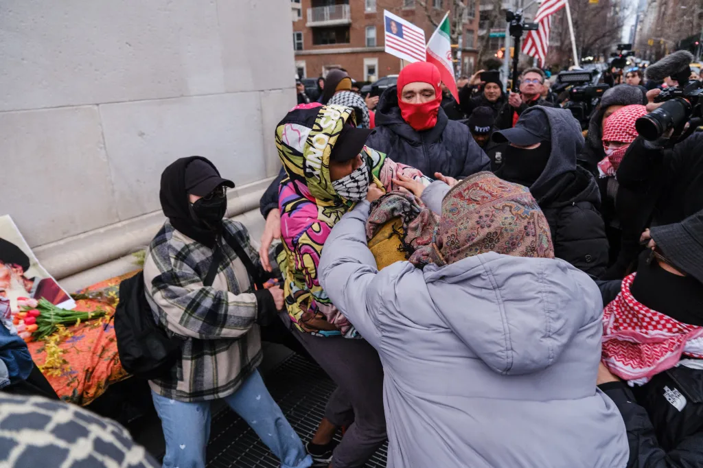 A fight breaking out between protestors at a vigil.