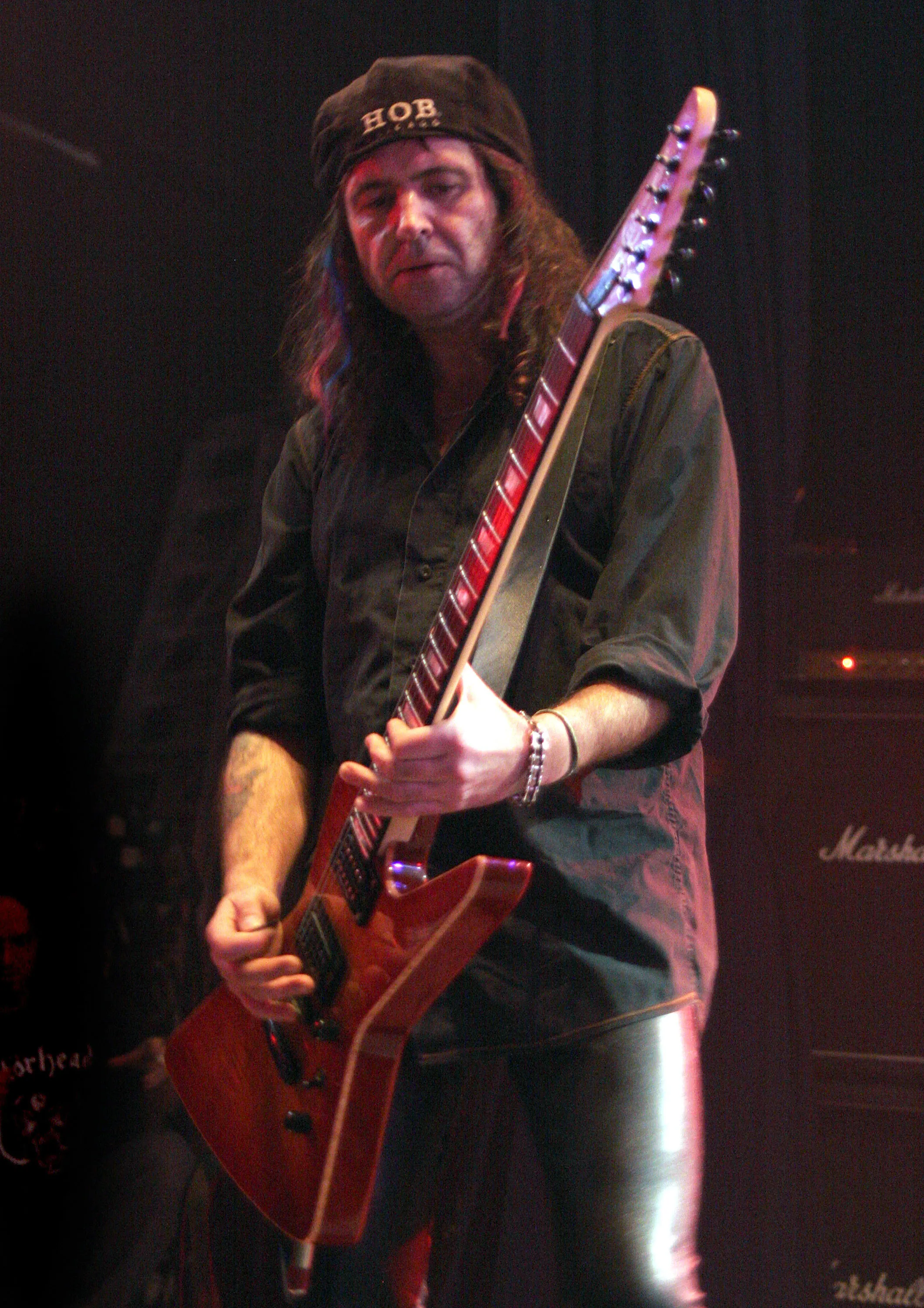 Phil Campbell of Motorhead performing on stage with his guitar.