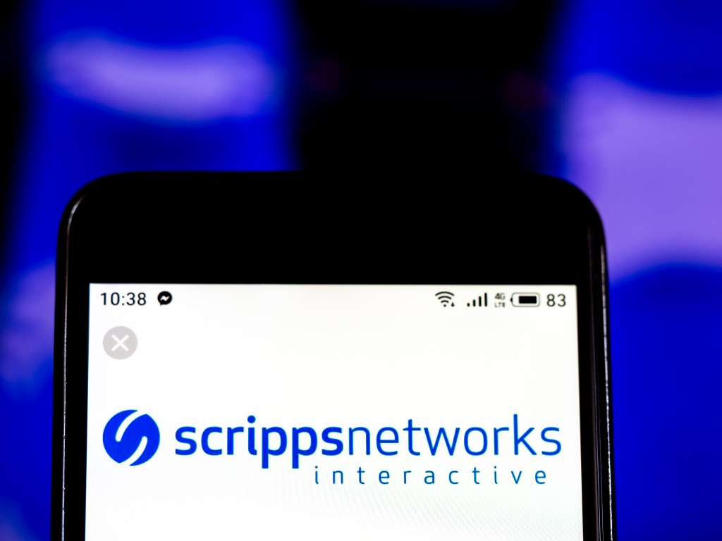 Illustration of the Scripps Networks Interactive Media company logo on a smartphone.
