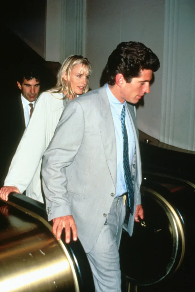 John F. Kennedy Jr. and Daryl Hannah walking together on an escalator.