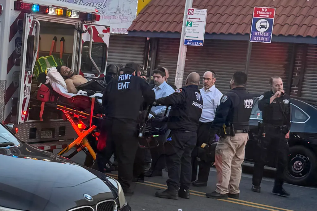 Suspected cop killer Guy Rivera on a stretcher being placed in an ambulance.