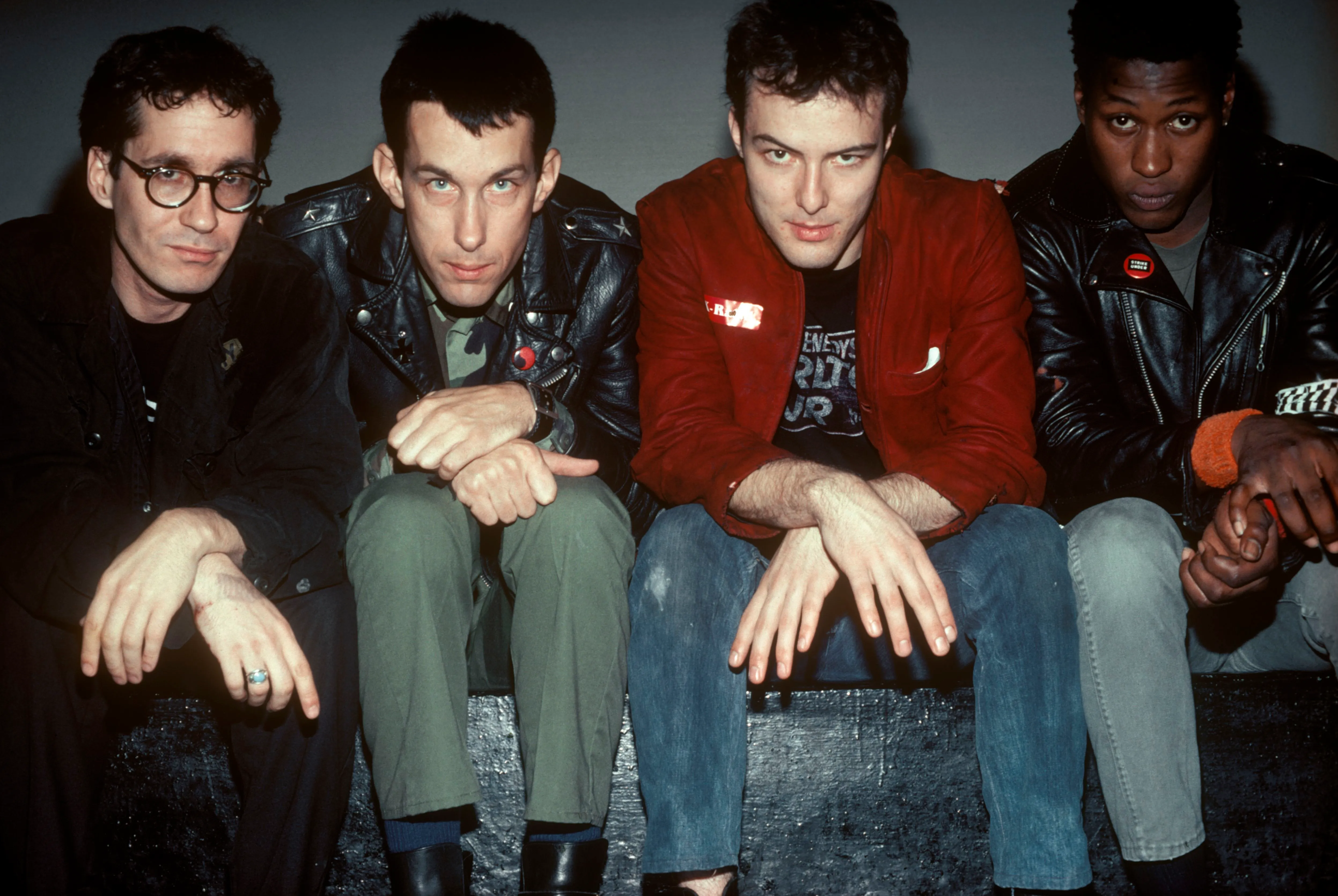 The band Dead Kennedys sitting together, looking at the camera.