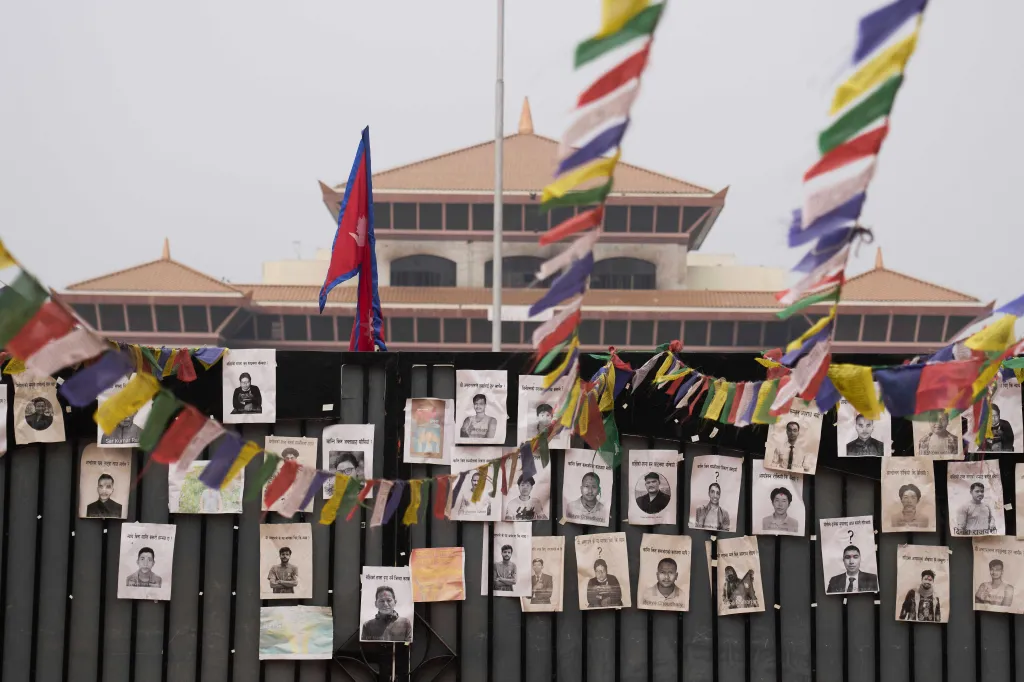 Photos of people who died in anti-corruption protests are placed on the parliament gate in Kathmandu, Nepal.
