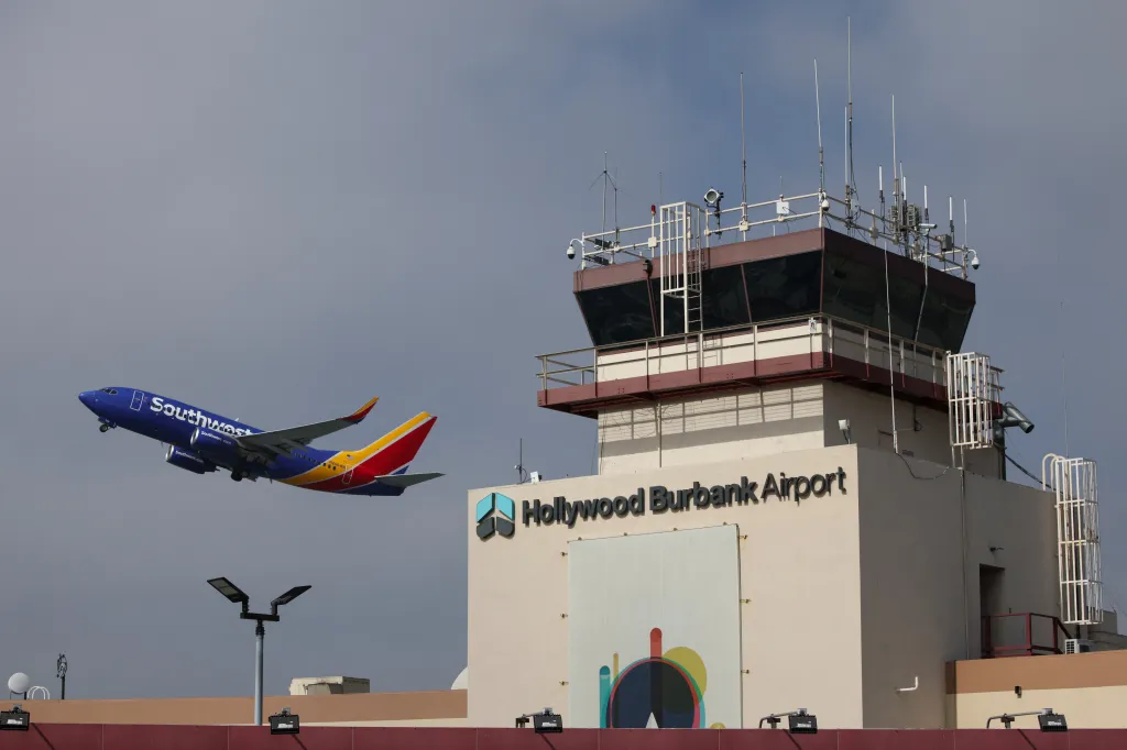 A Southwest Airlines plane takes off from Hollywood Burbank Airport, with its control tower visible in the background, signaling resumed operations after a U.S. government shutdown.