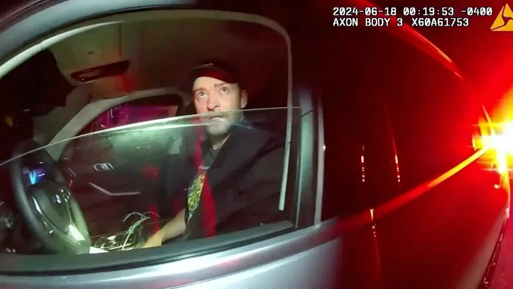 Justin Timberlake seated in a car during his arrest.