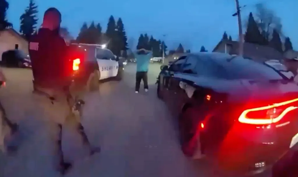 Bodycam video shows a deputy taking aim as a suspect stands with hands raised following a high-speed chase through a neighborhood.