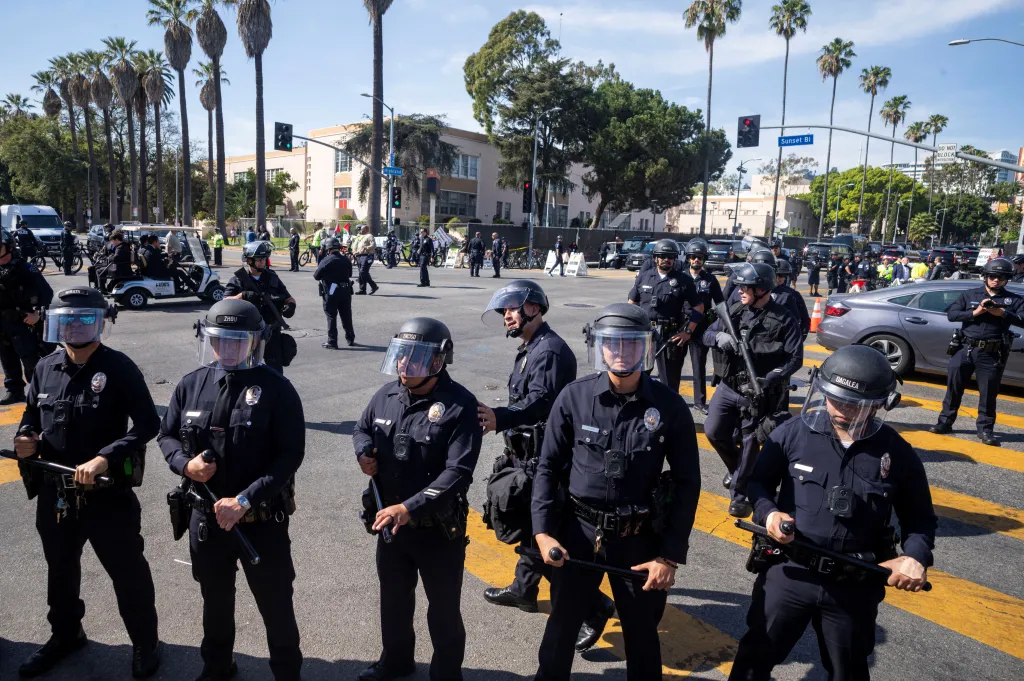 Police officers stand guard during a protest outside the venue of the Academy Awards in Los Angeles.