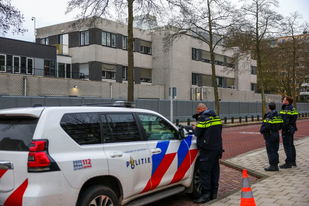 Police officers standing near a Jewish school following an explosion in Amsterdam.