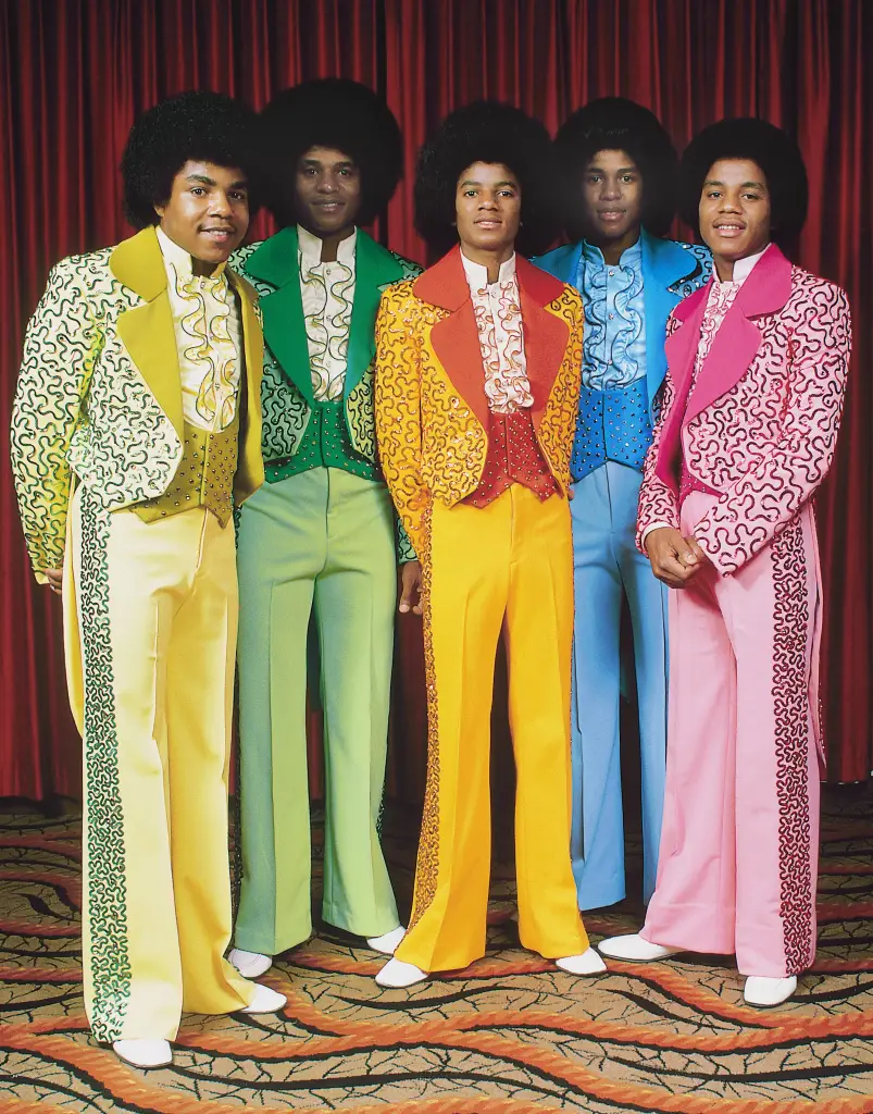 Posed group portrait of the Jackson 5 in outrageous clothes.