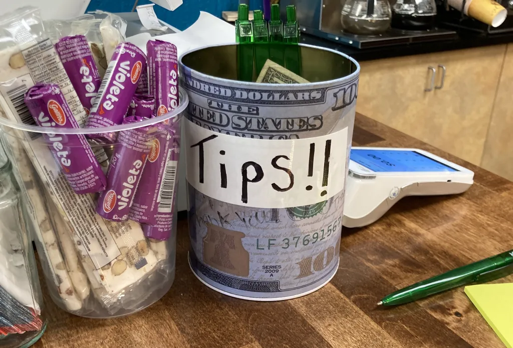 A tip jar labeled 