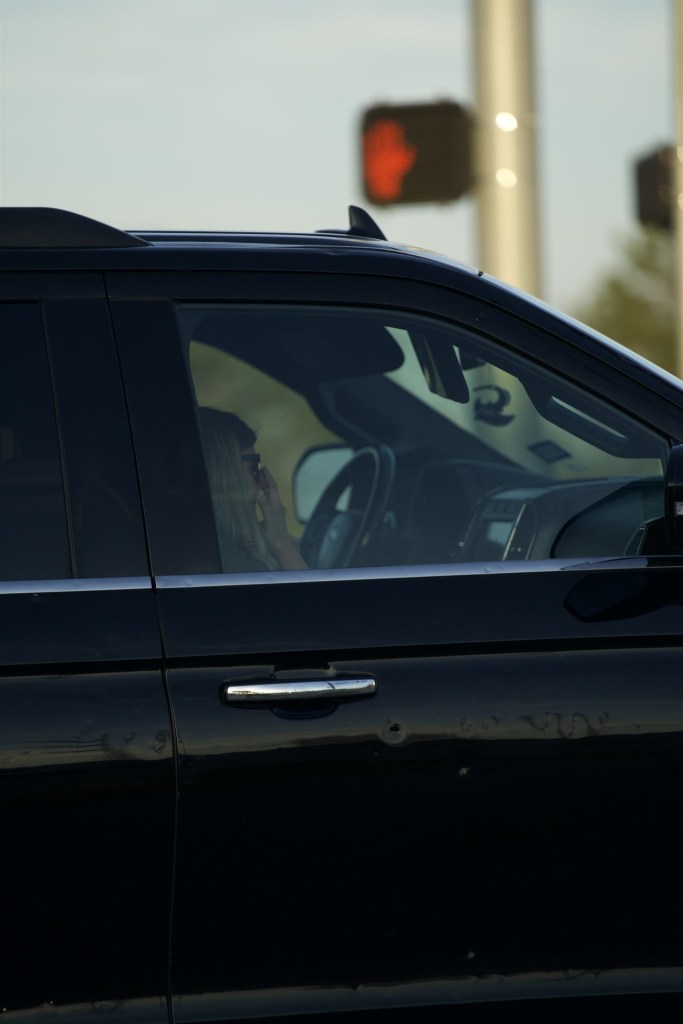 Kendra Duggar in a black car after her arrest.