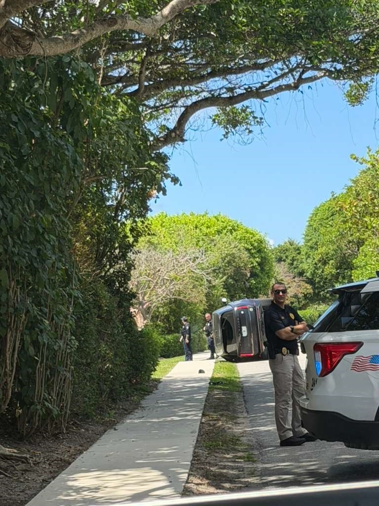 Tiger Woods' crashed car is seen turned on its side in Florida.