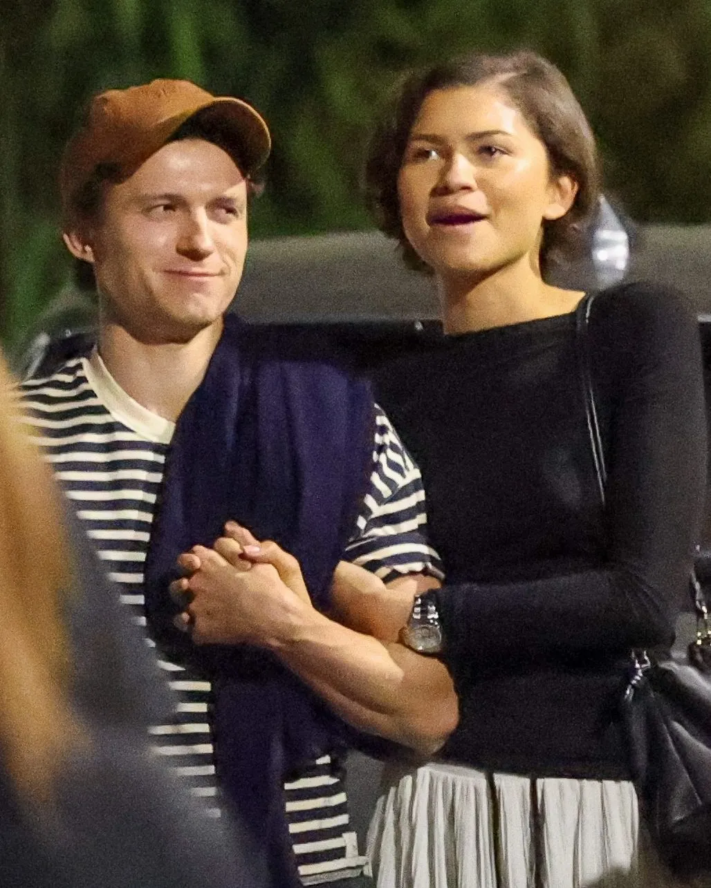 Zendaya and Tom Holland holding hands during a dinner outing in Los Angeles.