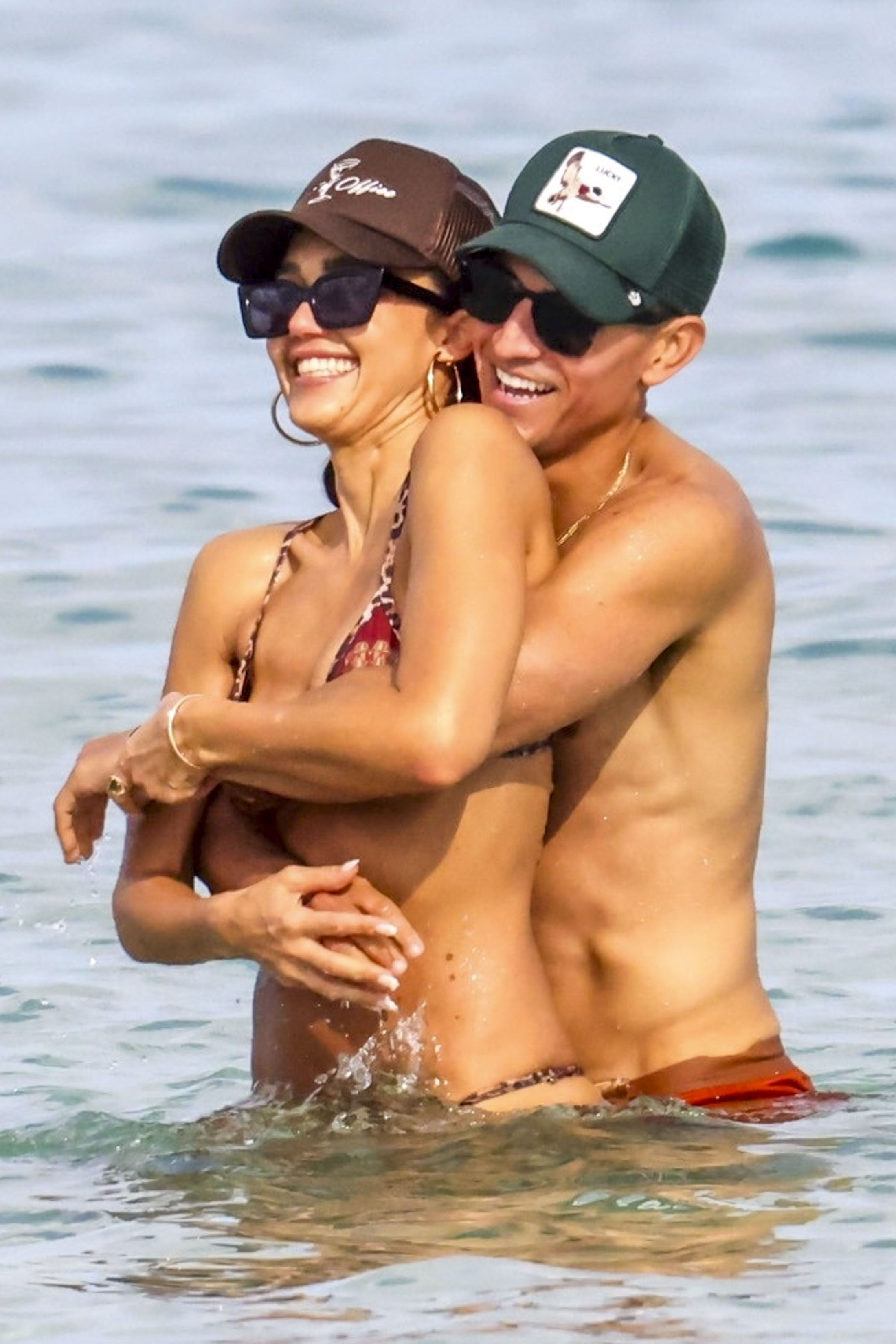 Jessica Alba and Danny Ramirez embracing each other in the ocean.