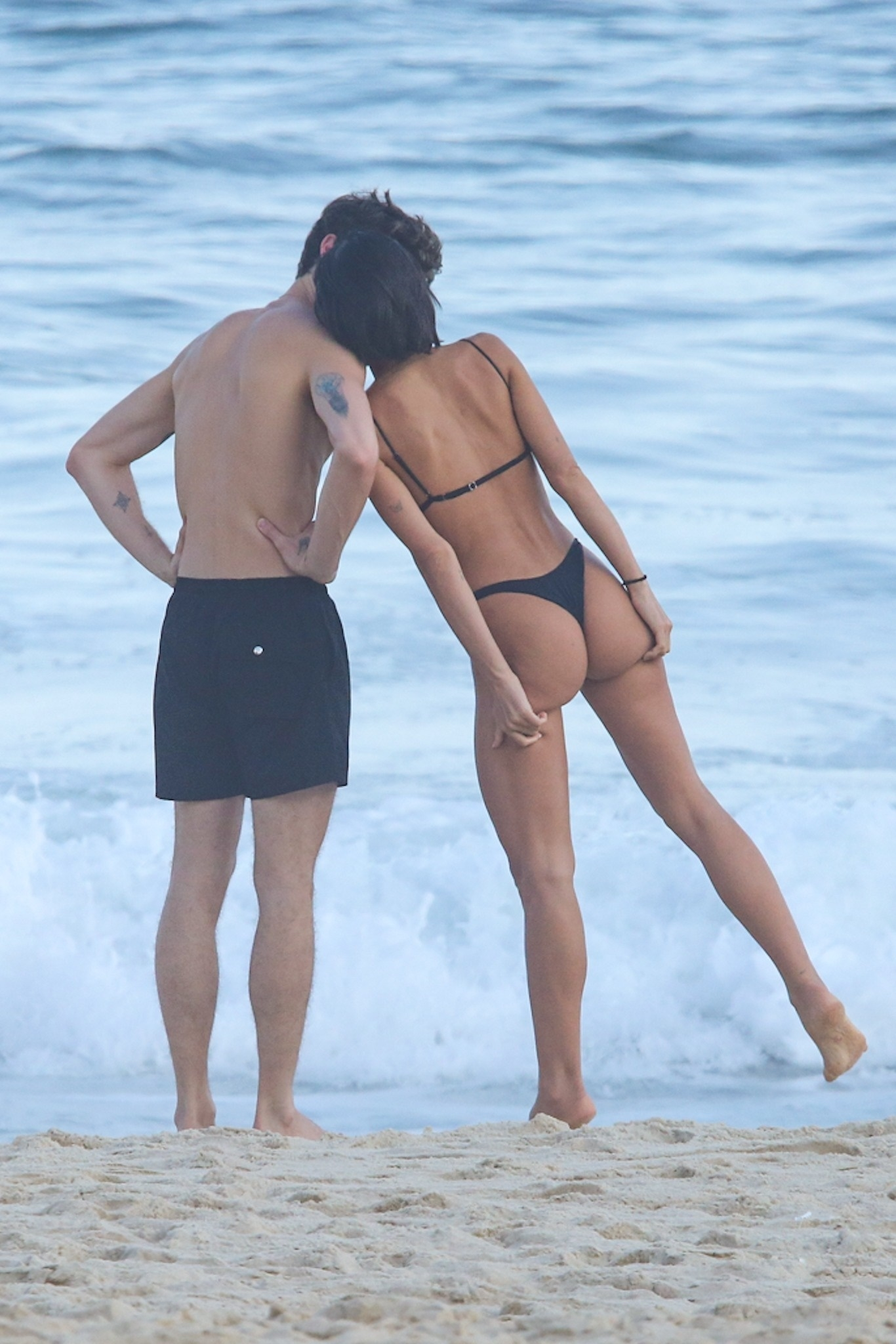 The pair kept close in the water, playfully kissing and chatting throughout the day.