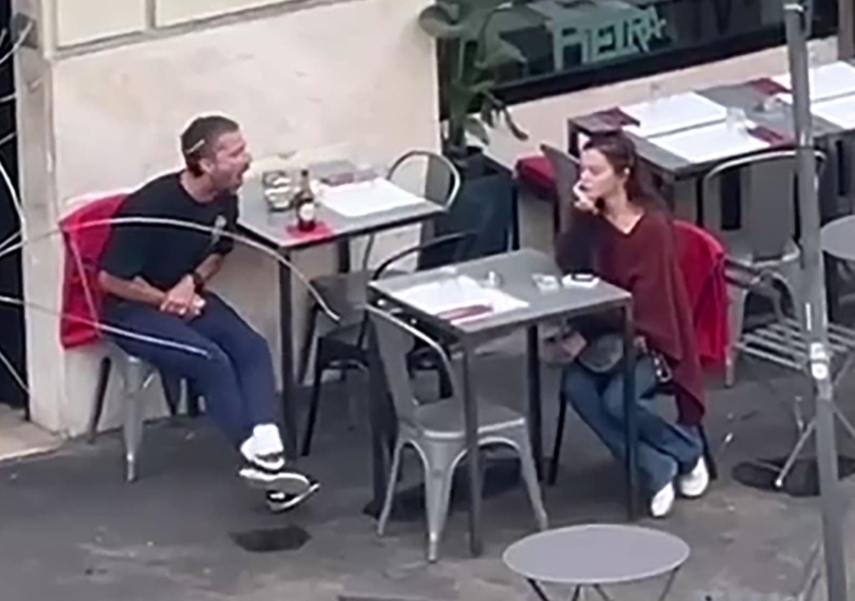 Actor Shia LaBeouf yelling at a woman while seated at an outdoor restaurant in Rome.