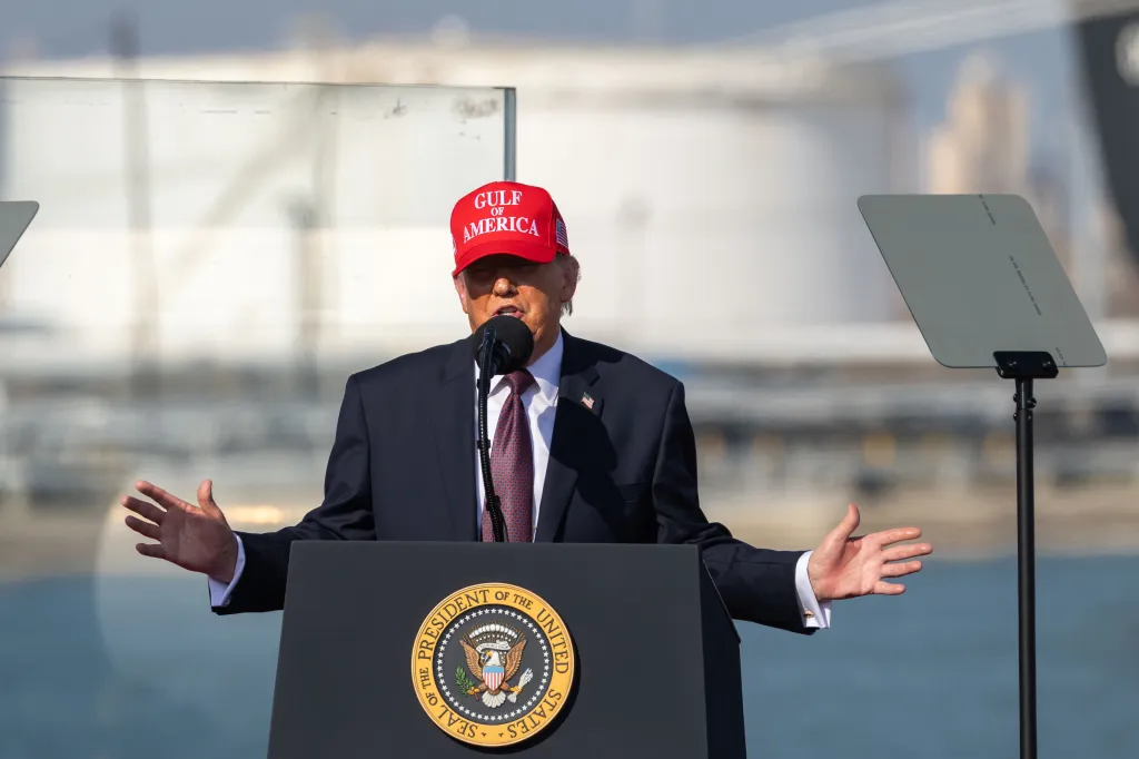 President Donald Trump speaking at a podium with the Seal of the President of the United States.