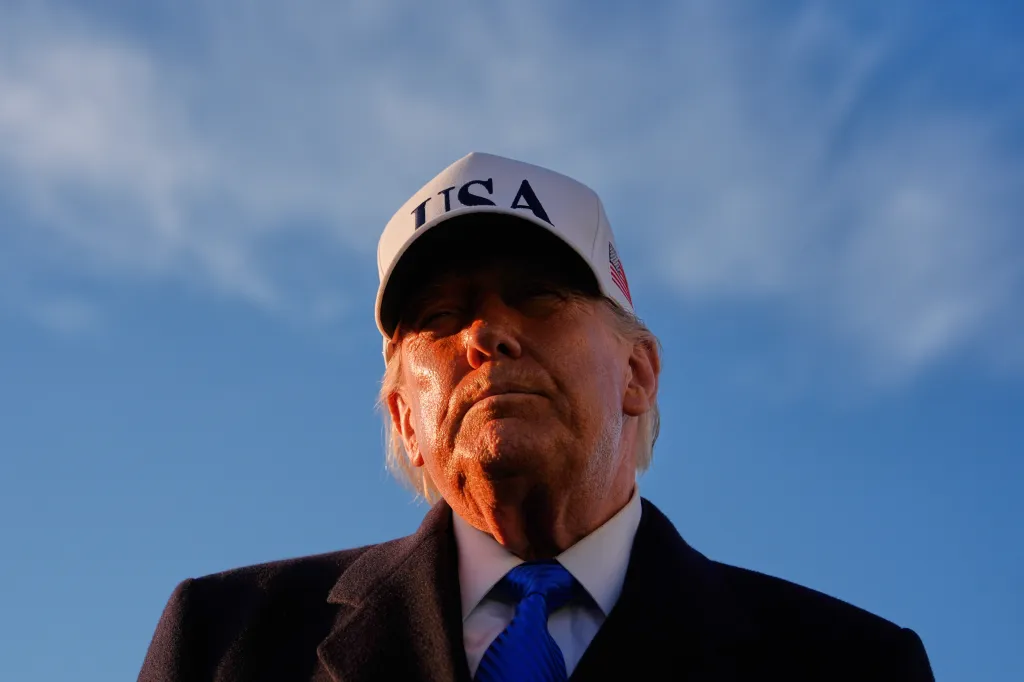 Donald Trump looking upwards while wearing a white 