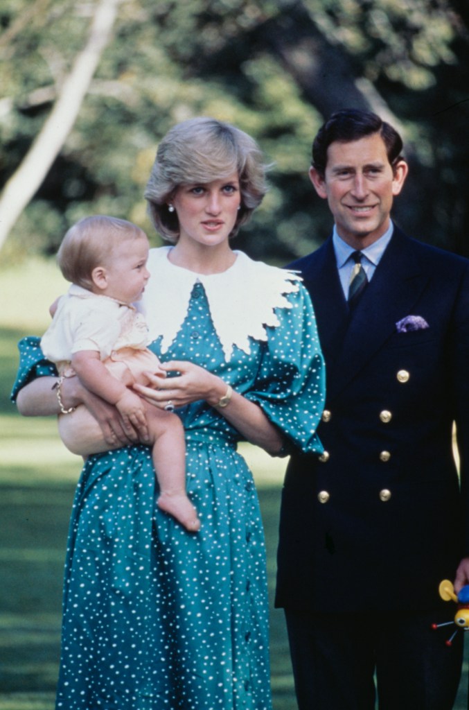 Princess Diana holding baby Prince William, with Prince Charles standing next to them.