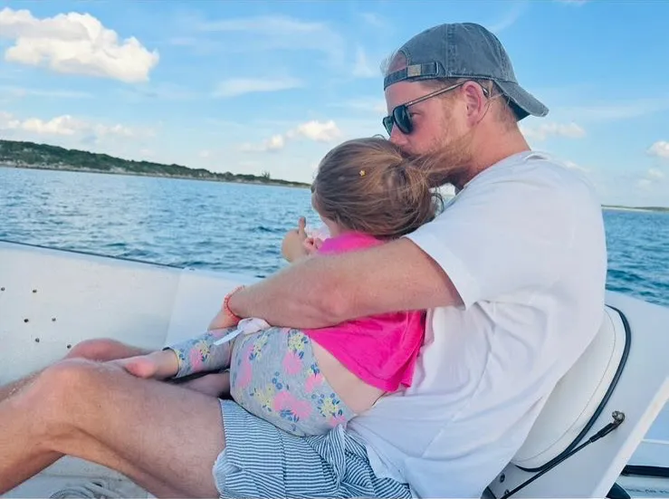 Prince Harry holding Princess Lilibet on a boat trip.