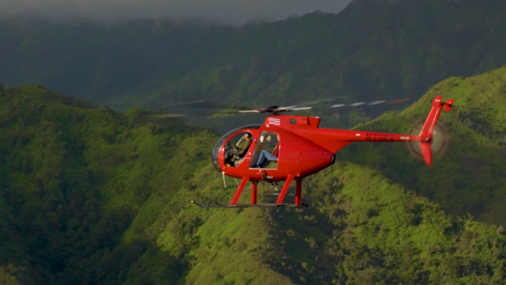 A helicopter from Airborne Aviation flies over Kauai, Hawaii.