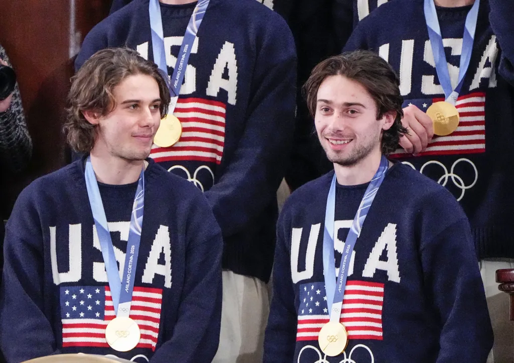 US Olympic Hockey team members and brothers Jack (L) and Quinn Hughes (R) wear their gold medals as President Donald Trump delivers his State of the Union address during a joint session of Congress in the House Chamber at the U.S. Capitol in Washington, DC