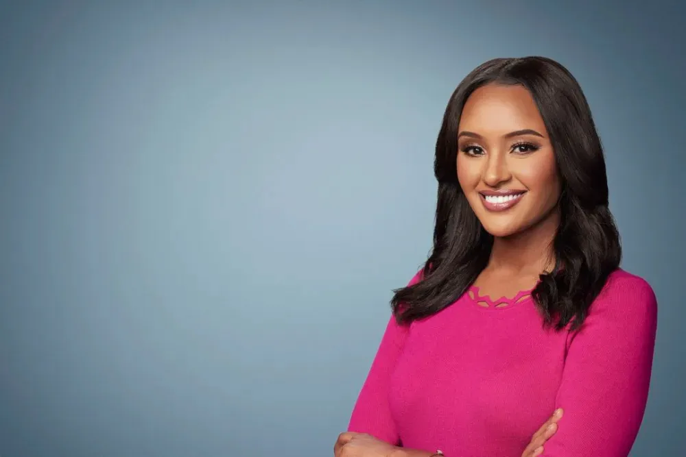 Rahel Solomon, host of Early Start on CNN, smiling with her arms crossed.