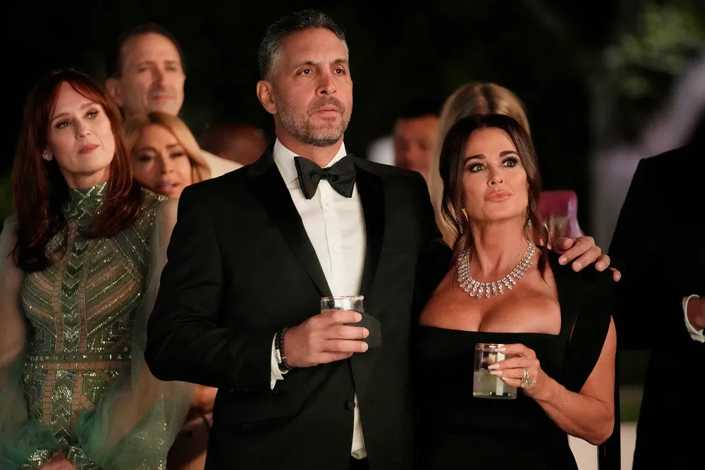 Mauricio Umansky and Kyle Richards posing together outdoors in winter clothing.