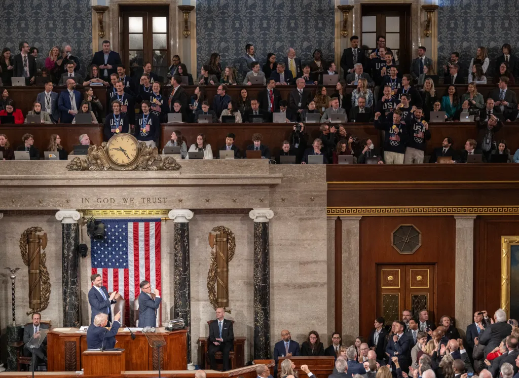 US President Donald Trump gestures to members of the US Men's Olympic hockey team during his State of the Union address.