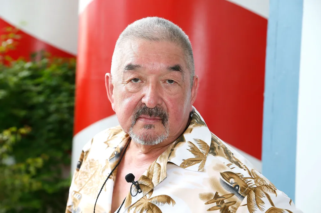 Academy Award-nominated actor Graham Greene with a microphone clipped to his Hawaiian shirt.