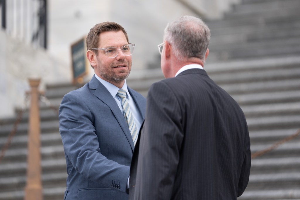 Rep. Eric Swalwell conversing with another man outside the Capitol.