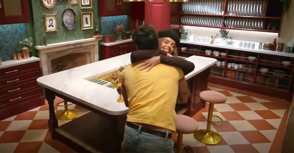 Rob Rausch embracing Maura Higgins in a kitchen.