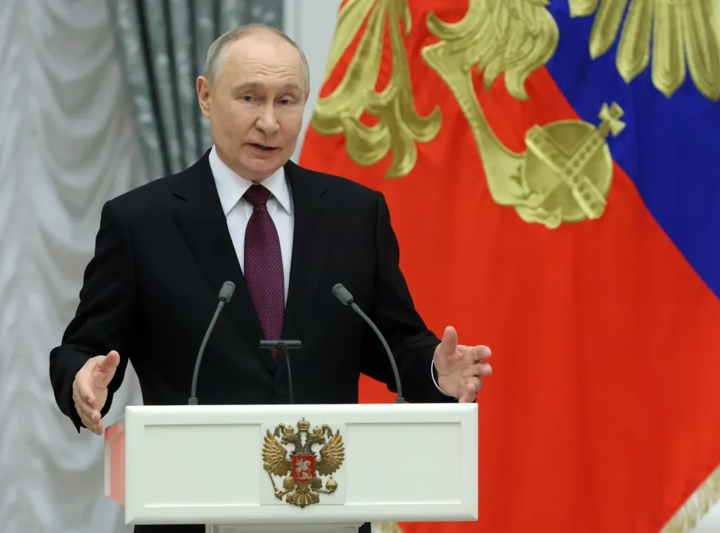 Russian President Vladimir Putin gestures during an awards ceremony.
