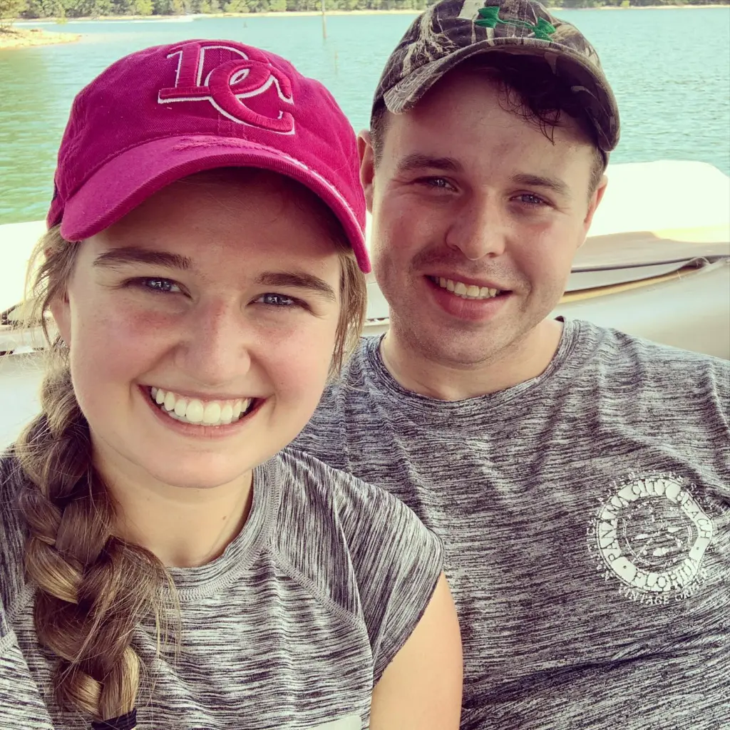 Joseph and Kendra Duggar smiling on a boat on a lake.