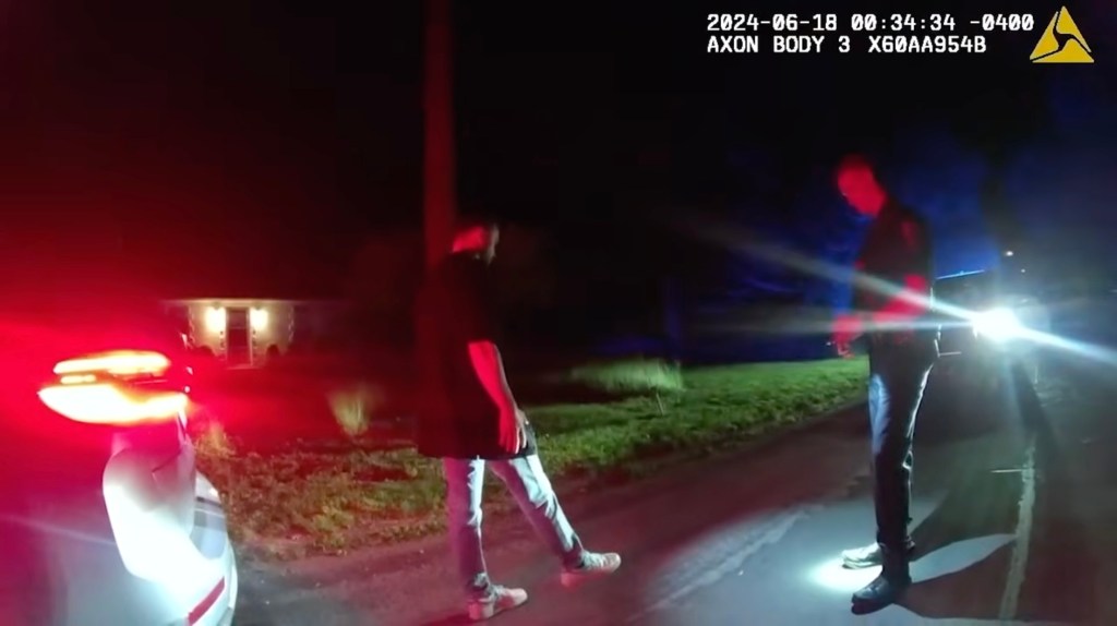 Bodycam footage shows Justin Timberlake performing a field sobriety test for a police officer at night.
