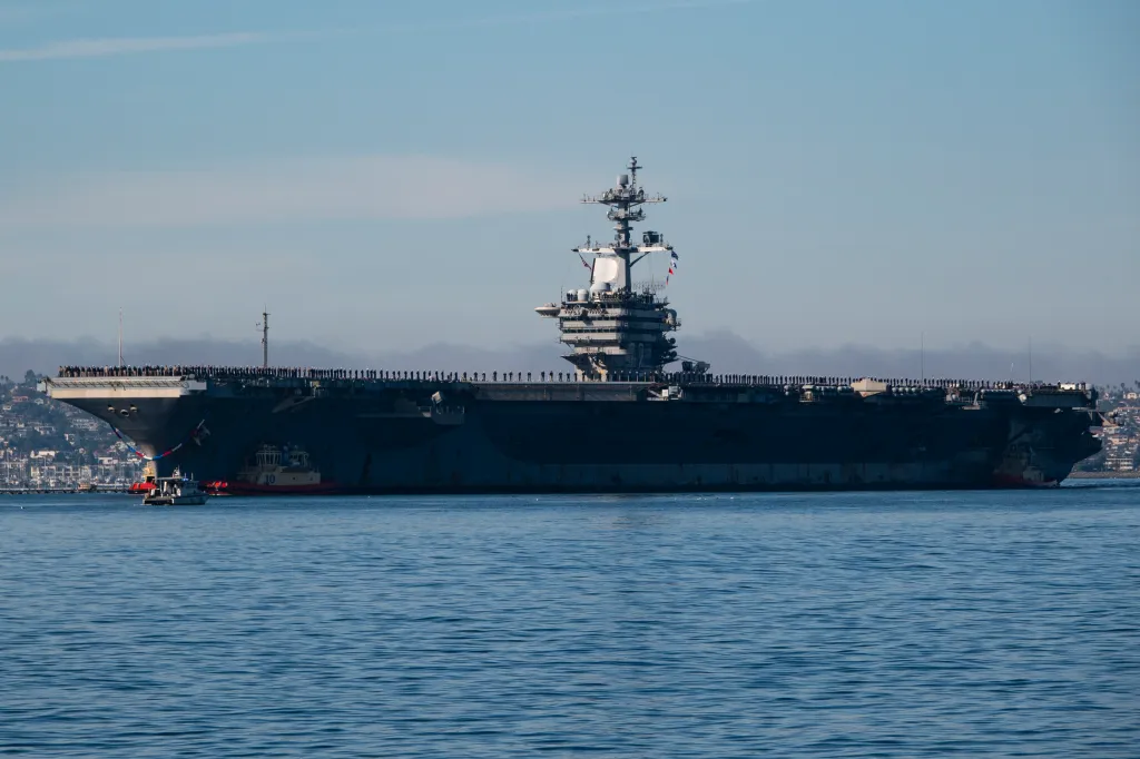 Sailors and Marines man the rail of the USS Abraham Lincoln as it returns to San Diego Bay.