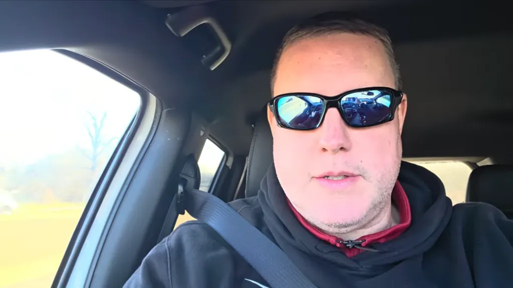 A 46-year-old man, Samuel McVey, wearing sunglasses and a hoodie while in a car.