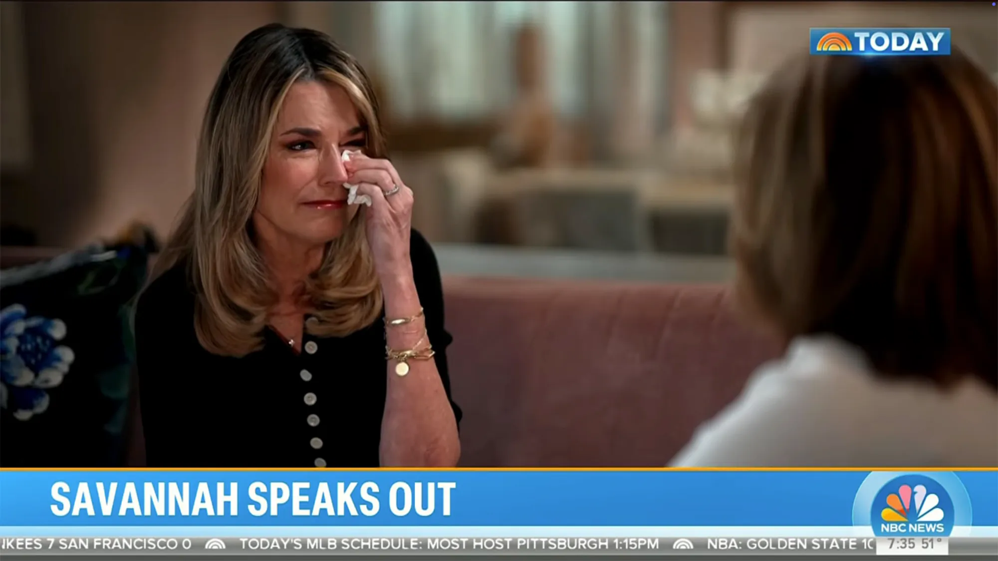 Savannah Guthrie crying and wiping her eye with a tissue during an interview on the Today Show.