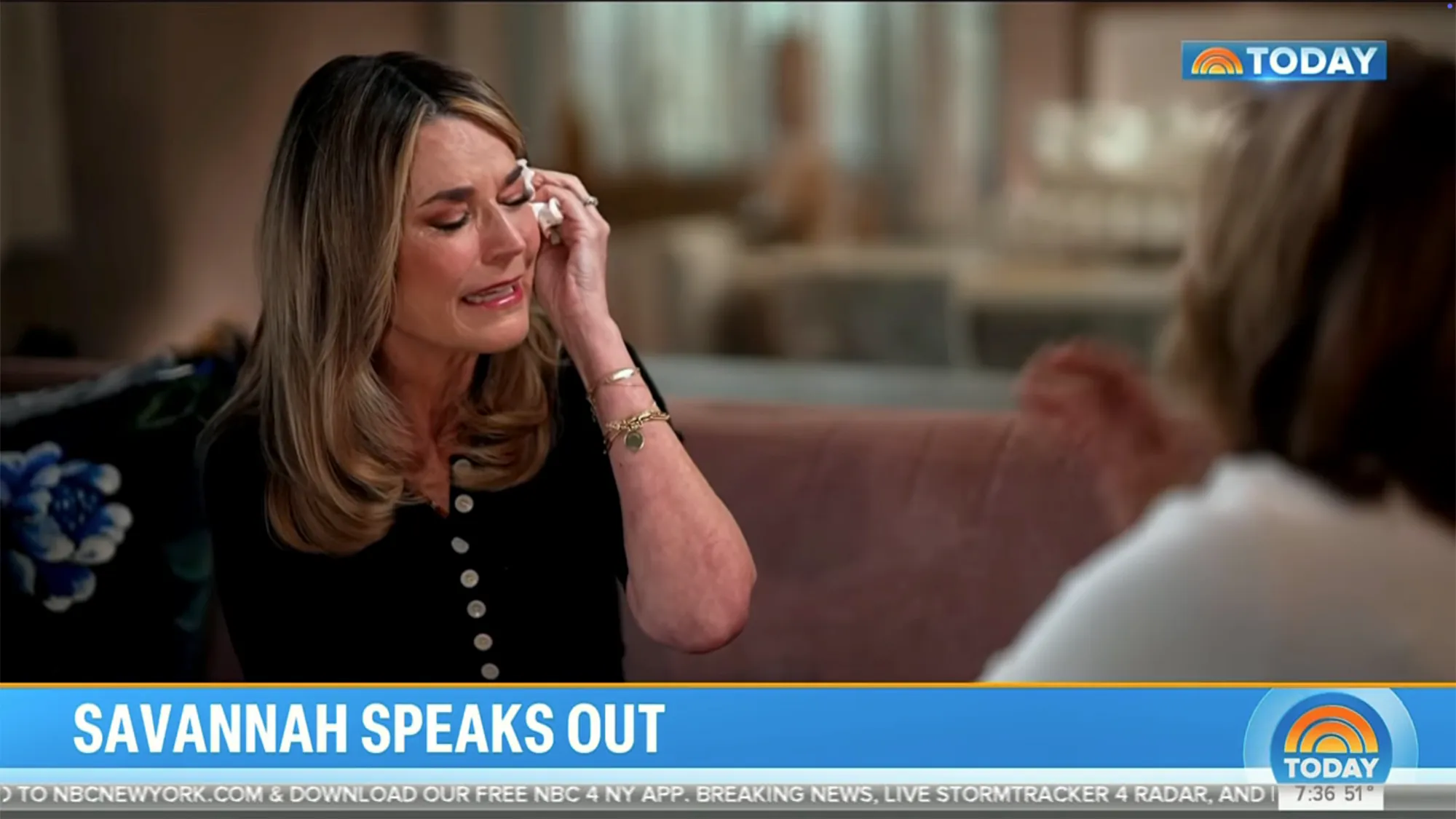 Savannah Guthrie crying and wiping her eye with a tissue during an interview.
