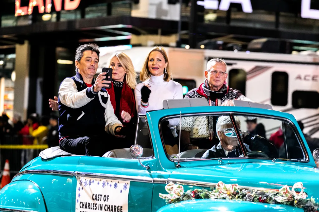 Scott Baio, Jennifer Runyon Corman, Josie Davis, and Willie Ames ride in a blue convertible during the 88th Annual Hollywood Christmas Parade.