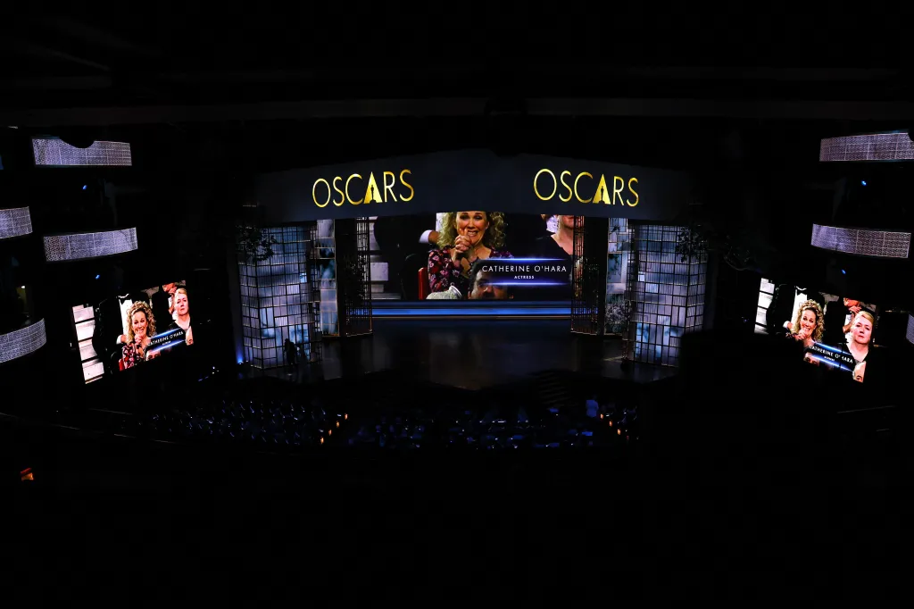 A screen showing a picture of Catherine O'Hara during the In Memoriam segment at the Oscars show.