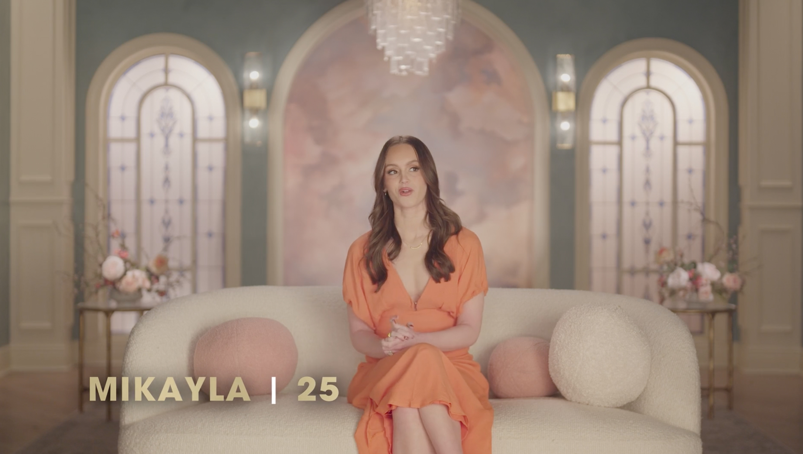 Mikayla Matthews, 25, seated on a white sofa in a confession for