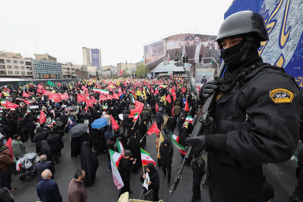 A security personnel stands guard as Iranians protest on al-Quds Day in Tehran.