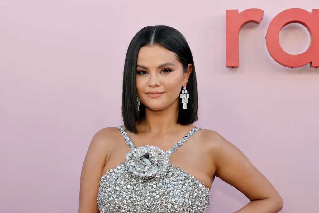 Selena Gomez in a sparkling silver dress and diamond earrings at the Rare Impact Fund Benefit.