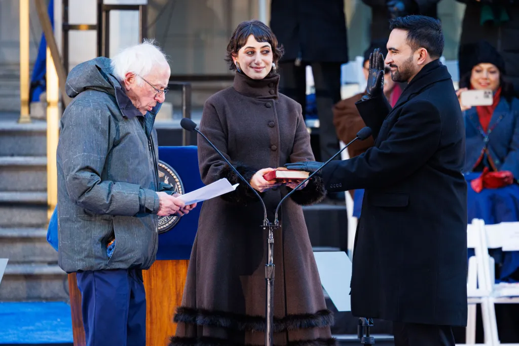 Senator Bernie Sanders swearing in New York City Mayor Zohran Kwame Mamdani, with Rama Duwaji holding a book.