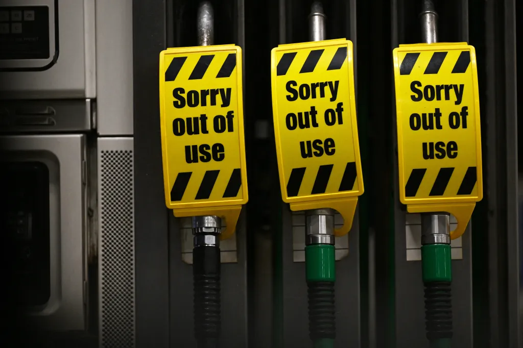 Three fuel pumps at a petrol station are marked with 