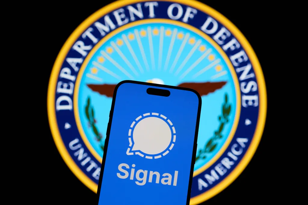 Illustration of the Signal messaging app on a phone with the US Department of Defense logo in the background.