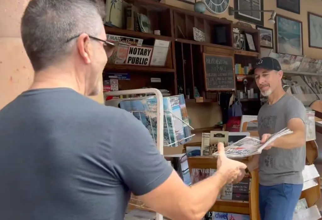 Simon Colwell buys a California Post newspaper at Malibu Newsstand.